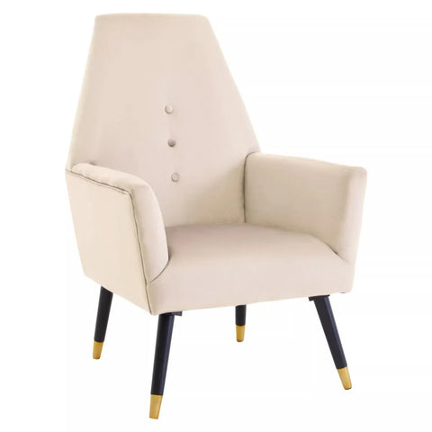 Beige velvet accent chair with button backrest, black tapered legs, gold tips, white background