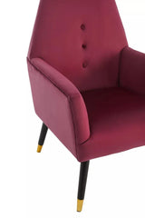 Wine velvet accent chair with button back detail and gold-tipped black legs, side angle view