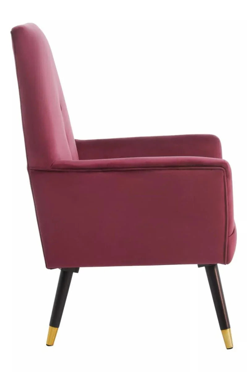 Wine velvet accent chair side view with tapered black legs and gold tips