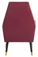 Back view of wine velvet accent chair with tapered black legs and gold tips