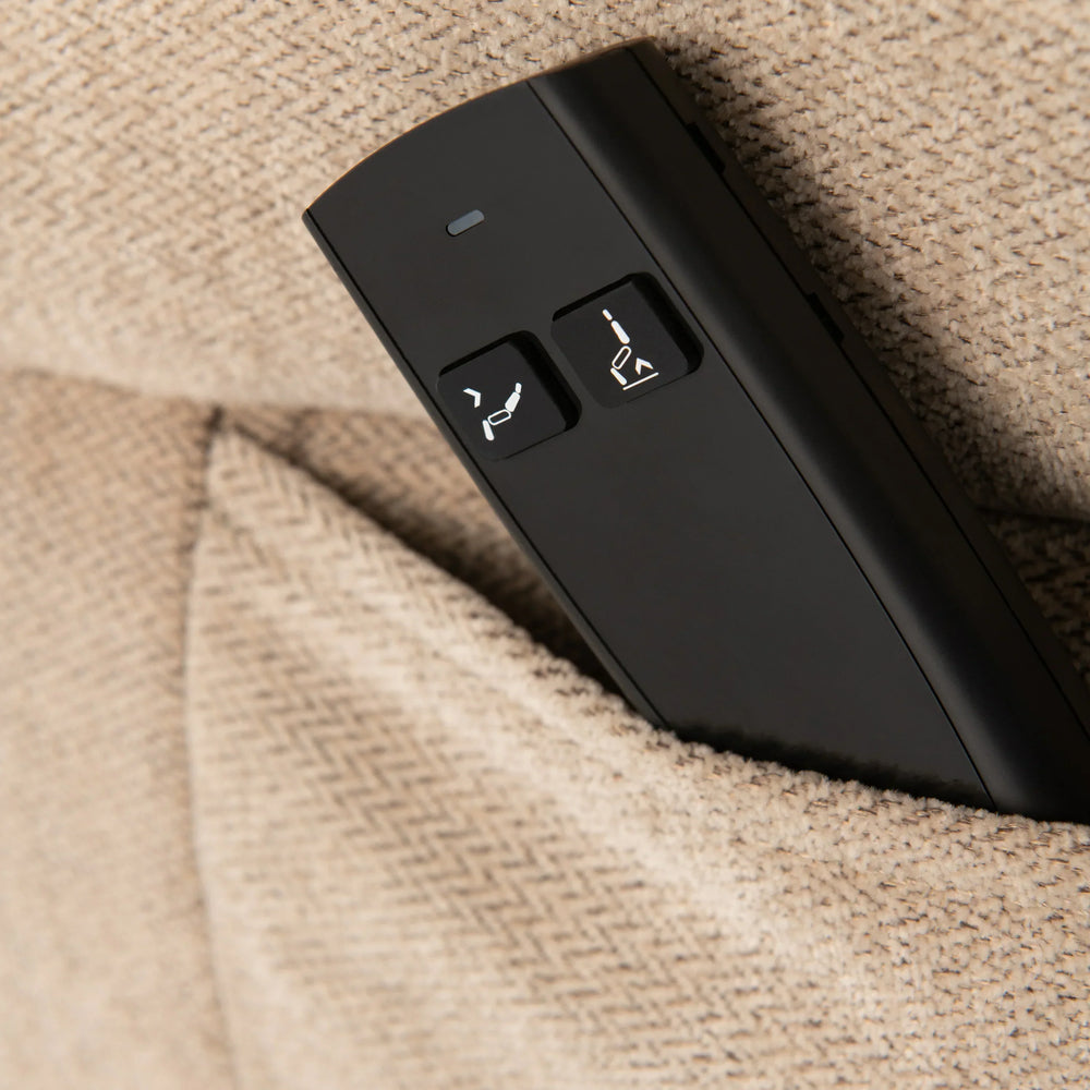 Recliner sofa remote with control buttons in beige fabric pocket