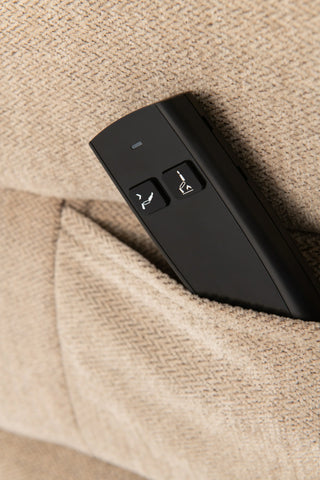 Recliner sofa remote with control buttons in beige fabric pocket