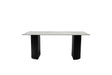 A modern rectangular dining table with a light gray stone or concrete-look top and two thick black pedestal legs, shown against a plain white background.