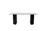 A modern rectangular dining table with a light gray stone or concrete-look top and two thick black pedestal legs, shown against a plain white background.