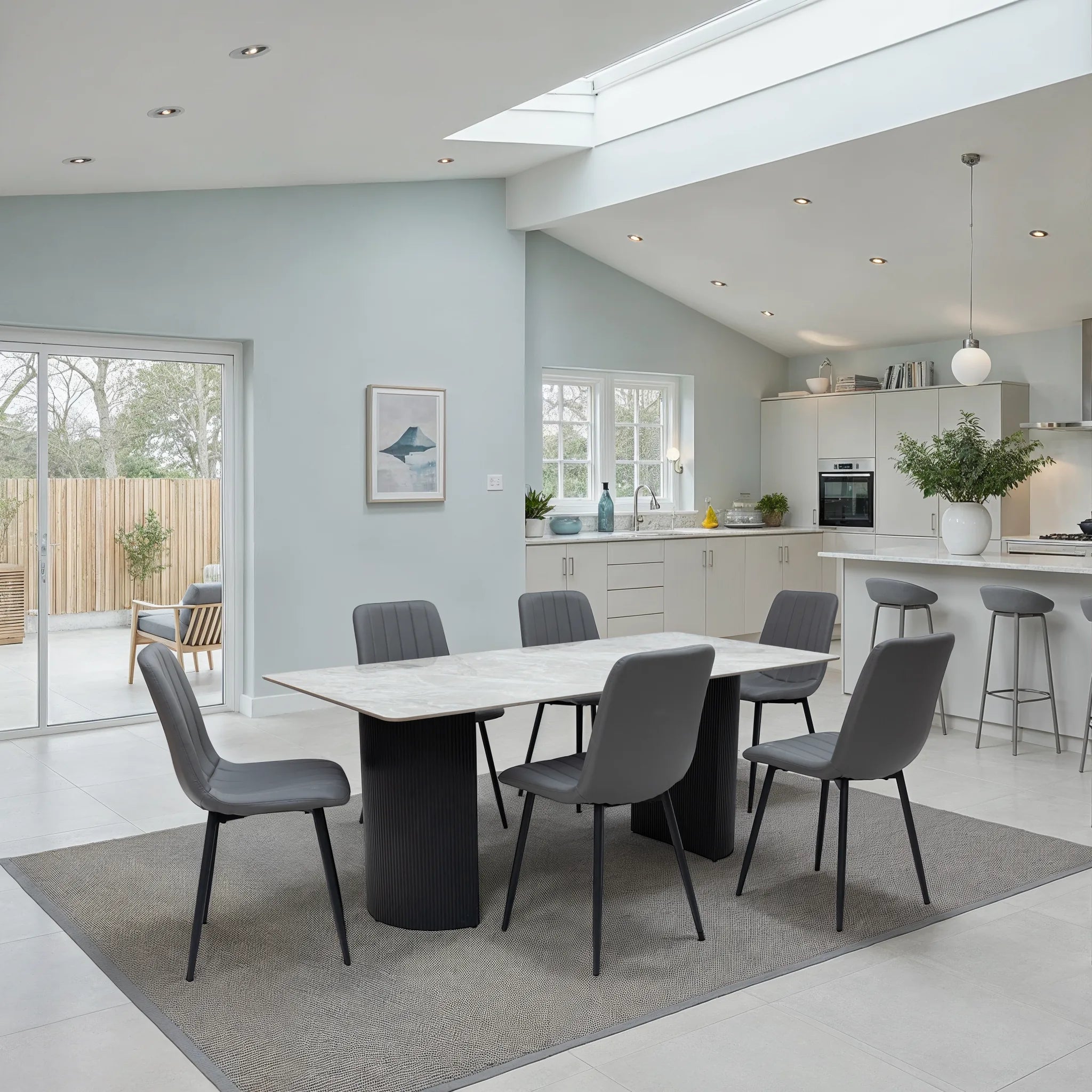 Modern kitchen and dining area with a table and chairs.