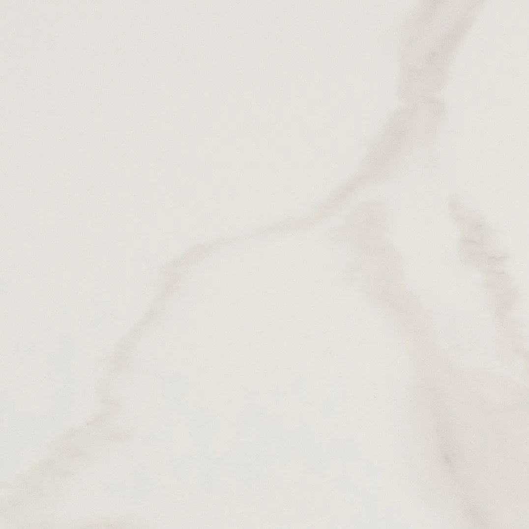 A close-up of a light warm off-white surface with soft gray marble-like veining.