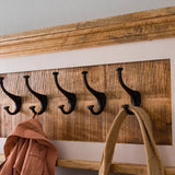 Handcrafted mango wood coat hanger with a whiteish finish