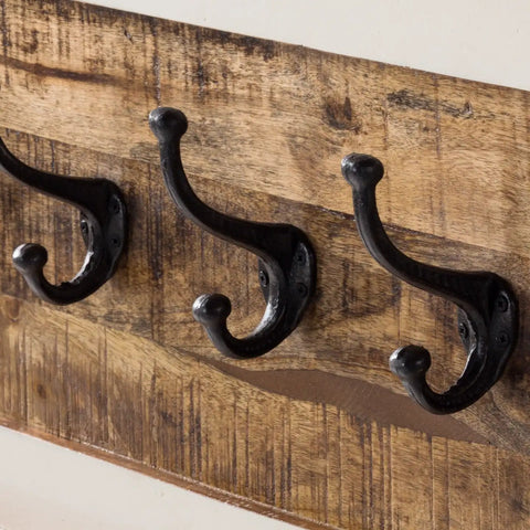 Handcrafted mango wood coat hanger with a whiteish finish