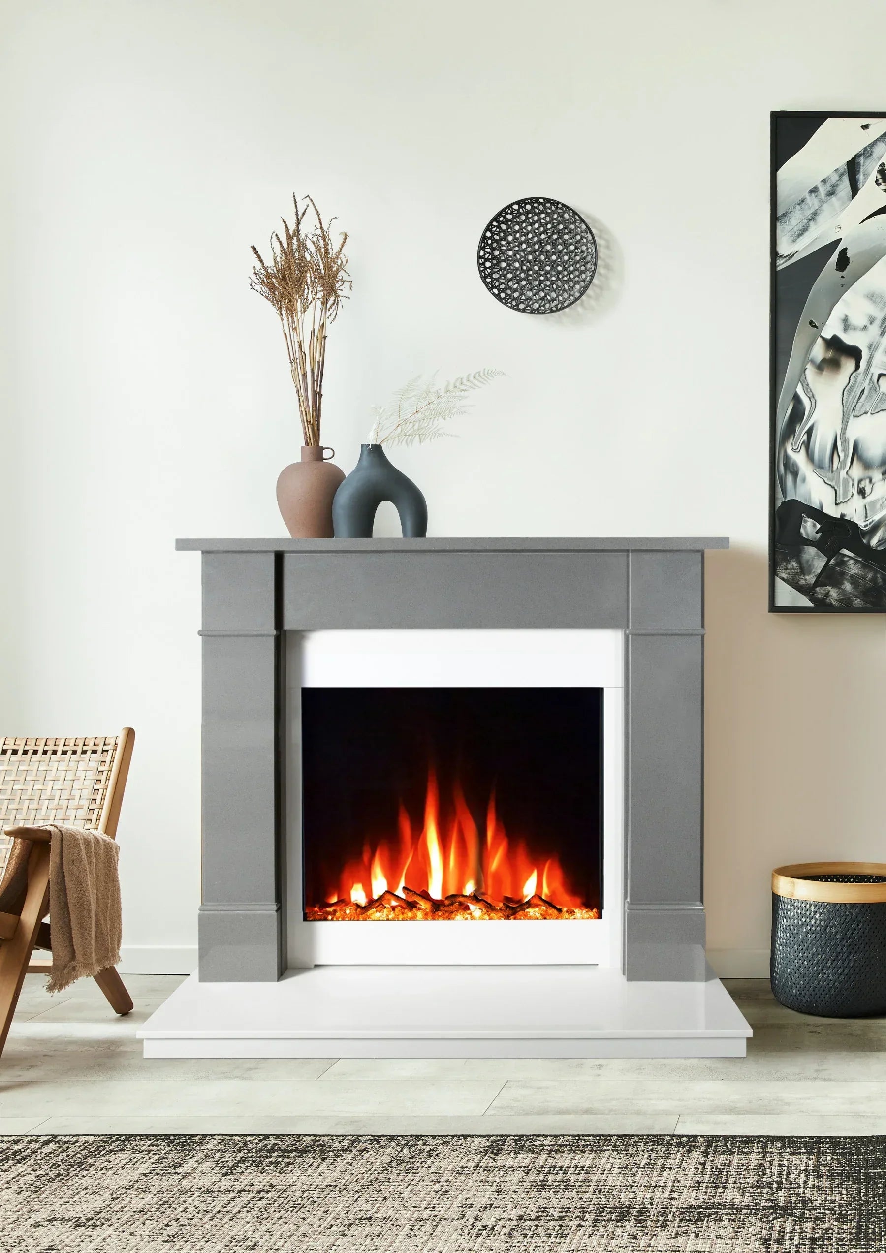 Grey electric fireplace with glowing fire, modern decor vases, and abstract wall art