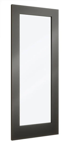Tall rectangular wall mirror with black frame reflecting minimal light