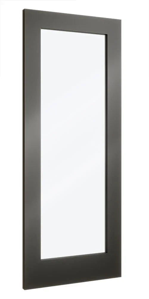Tall rectangular wall mirror with black frame reflecting minimal light