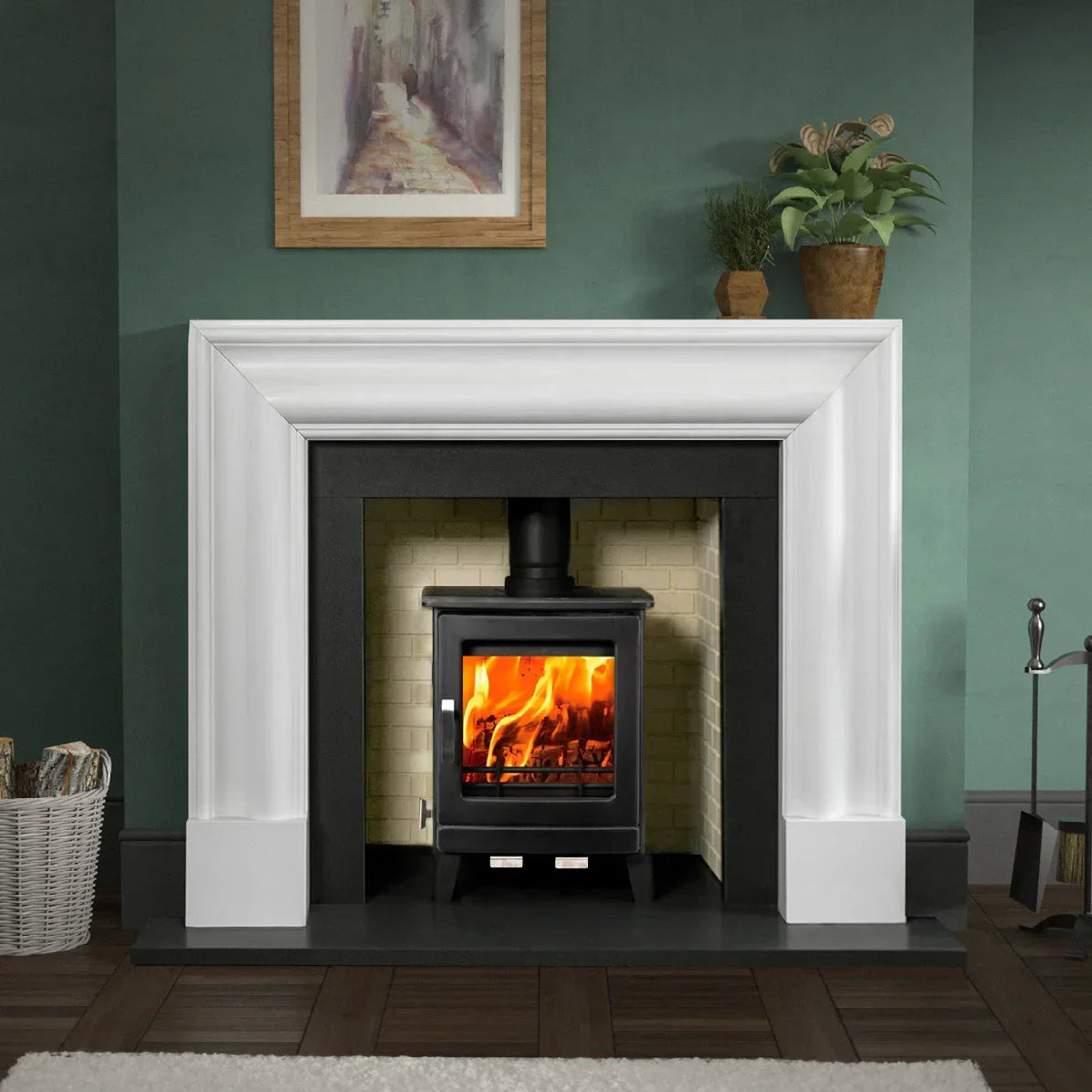 Modern wood burning stove with glass door in white fireplace surround on hardwood floor