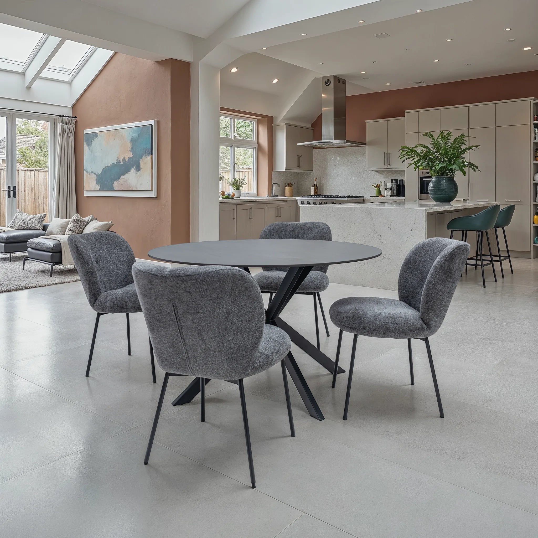 Modern dining area with gray chairs and a round table in a stylish home interior.