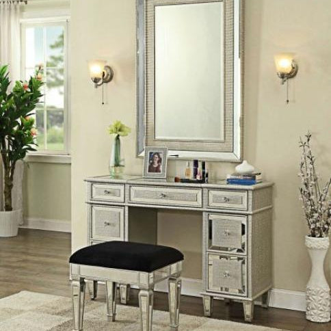 Mirrored dressing table set with black cushioned stool and large wall mirror in bedroom