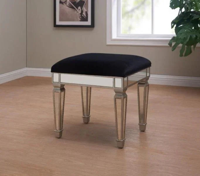 Mirrored stool with black cushioned seat and tapered legs on wood floor in modern room