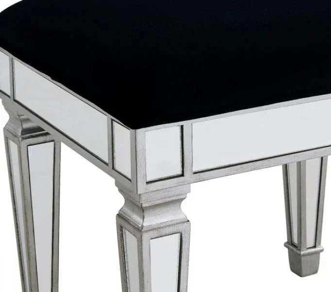 Mirrored bedroom stool with black velvet seat and silver trim, angled close-up view