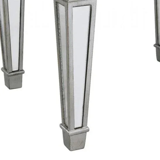 Mirrored furniture legs with silver trim and geometric design