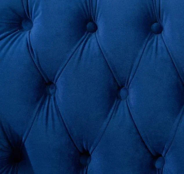 Blue velvet upholstered headboard with deep button tufting detail