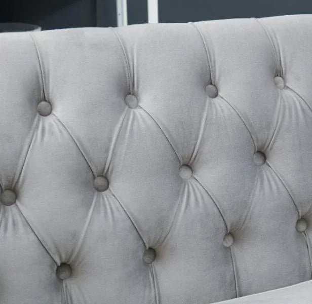 Close up of grey tufted velvet dining chair backrest with button detail