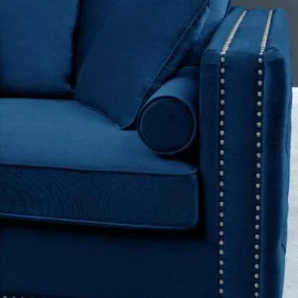 Blue velvet sofa with studded armrest and matching scatter cushions