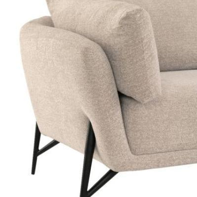 Beige fabric sofa corner with angled black metal legs and plush armrest