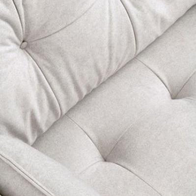 Close up of light grey fabric sofa with tufted backrest and seat cushions