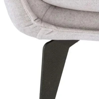 Close-up of grey fabric sofa corner with black metal leg