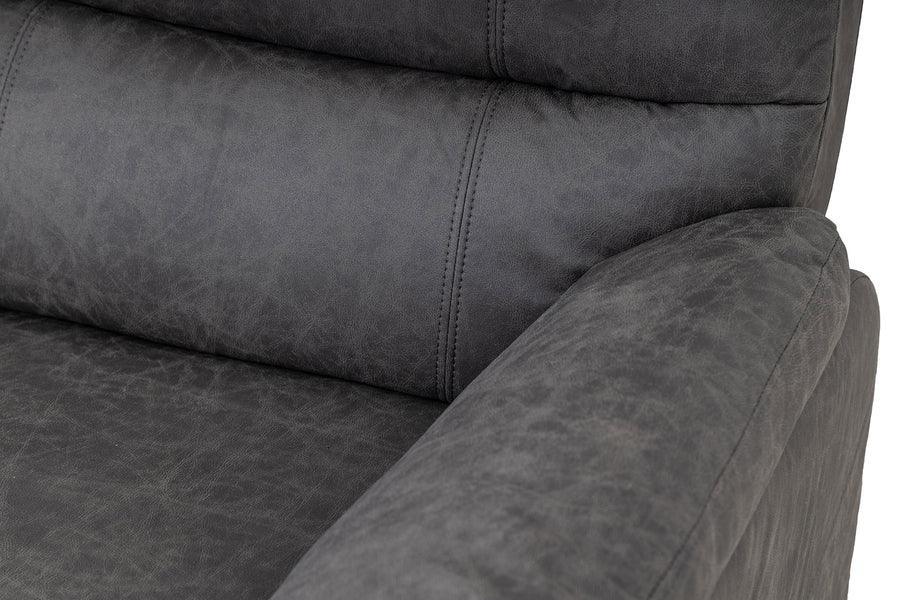 Close-up of dark grey fabric sofa arm and cushioned backrest with stitched detail
