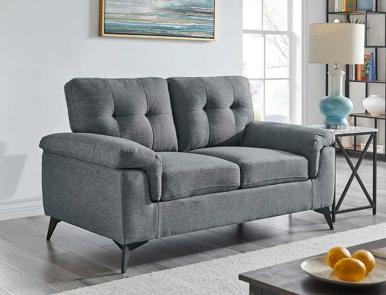 Grey fabric sofa with tufted cushions and angled legs in modern living room setting
