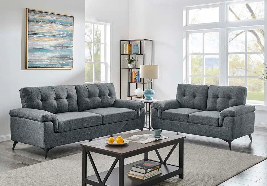 Grey fabric sofa set with button-tufted cushions in modern living room