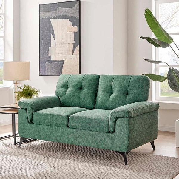Green fabric sofa with tufted backrest and slim black legs in modern living room setting