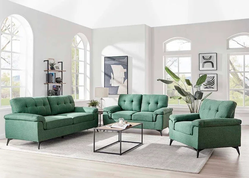 Green fabric sofa set with modern coffee table in bright living room with large windows