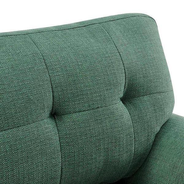 Green fabric sofa backrest with tufted upholstery closeup