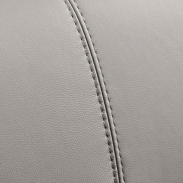 Closeup of grey leather sofa upholstery with visible stitching detail