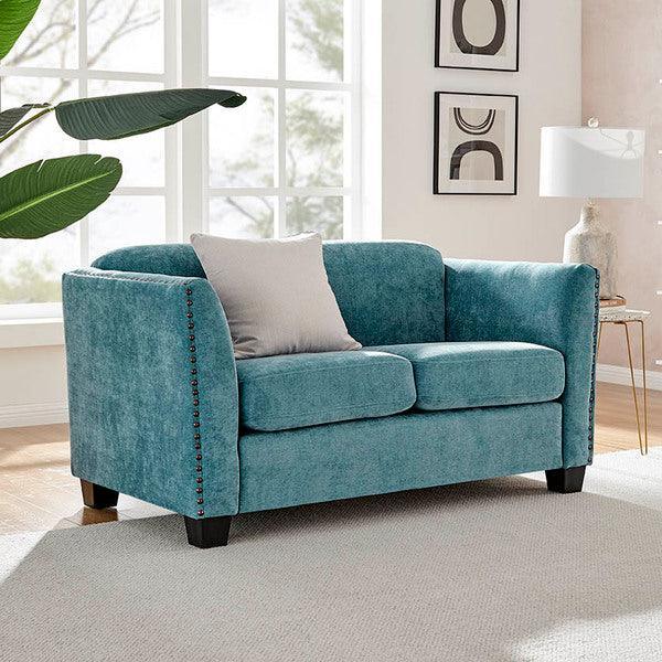 Teal fabric sofa with studded arms and single cushion in a bright living room