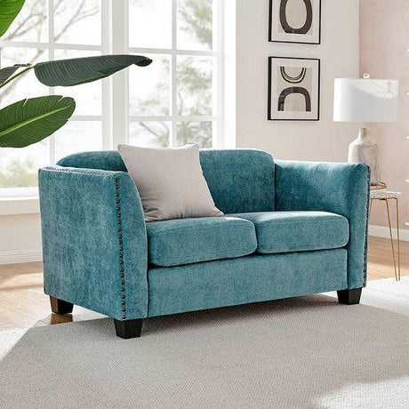 Teal fabric sofa with studded arms and single cushion in a bright living room
