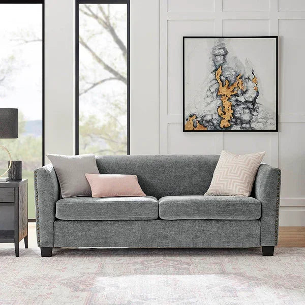 Grey fabric sofa with two scatter cushions in modern living room setting