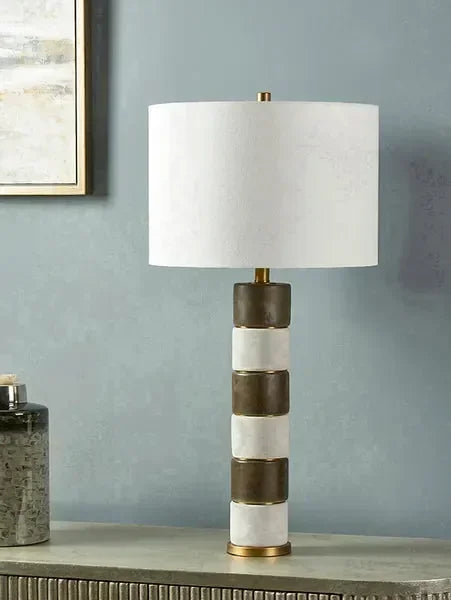 Modern table lamp with striped ceramic base and white fabric lampshade on console