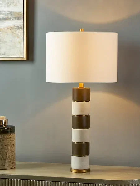 Modern table lamp with white and gold stripe ceramic base and round fabric shade