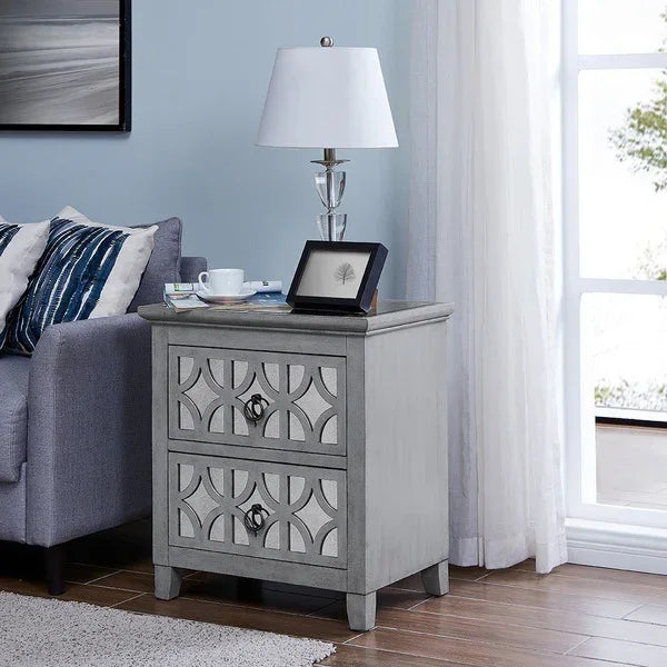 Grey two drawer bedside table with geometric pattern beside sofa in living room