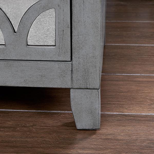 Grey wooden furniture leg and panel detail on dark wood floor