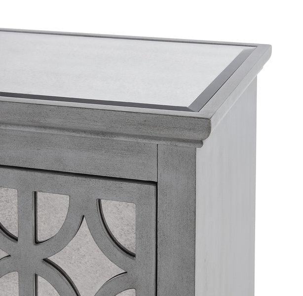 Grey mirrored furniture corner with geometric panel detail and glass top