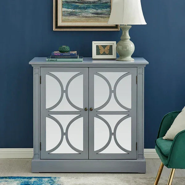 Grey sideboard cabinet with mirrored doors and geometric design against blue wall