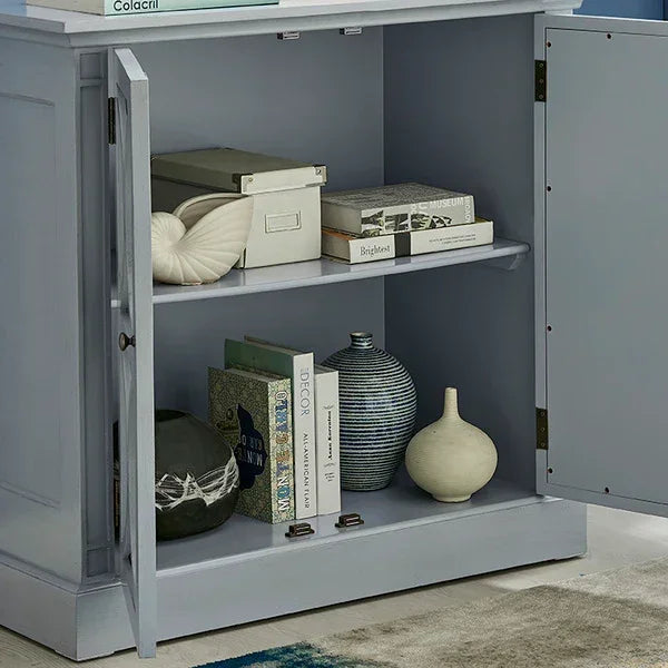 Light grey storage cabinet with open doors, books, vases and decorative boxes on shelves