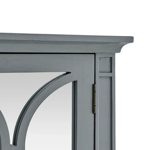 Grey wooden cabinet door with decorative glass panel and brass hinge, close up view