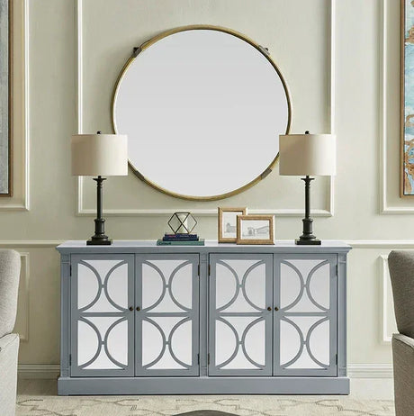 Grey mirrored sideboard with geometric doors, two table lamps, and round wall mirror