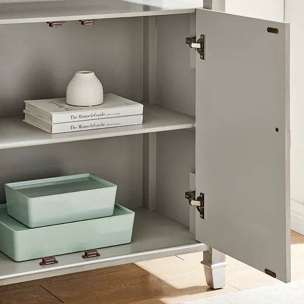 Grey storage cabinet with open door, shelves holding decorative boxes and books