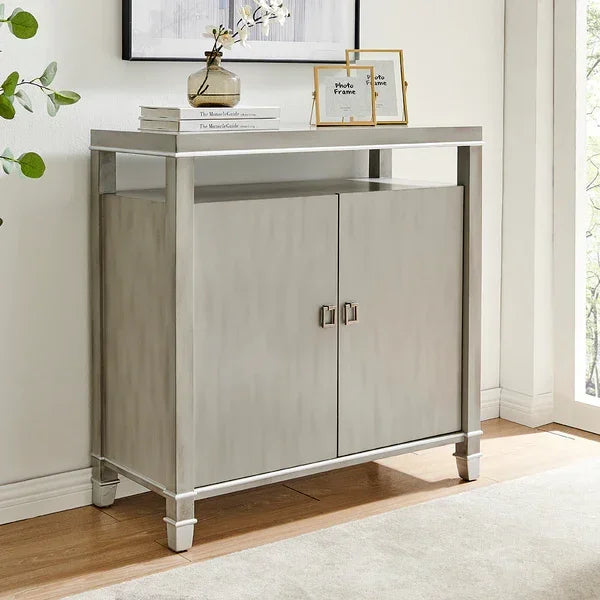 Modern grey storage cabinet with chrome legs, double doors, and open shelf in bright room