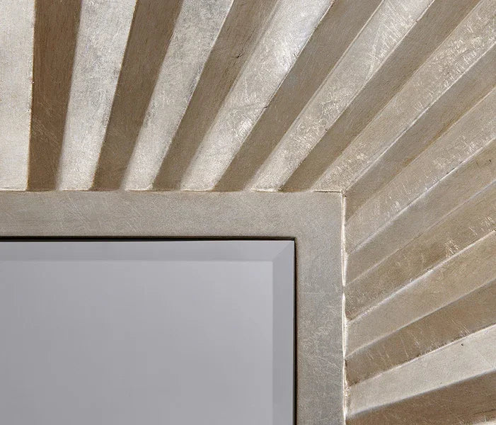 Silver sunburst wall mirror frame with textured metallic finish, close-up corner detail