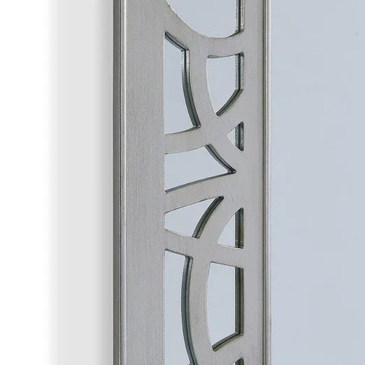 Close up of silver mirror frame with geometric cut-out metal design